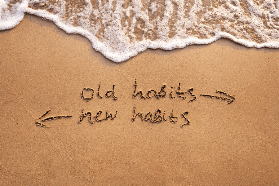 habits written on the beach
